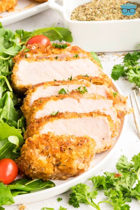 A Parmesan Crusted Pork Chop sliced up.