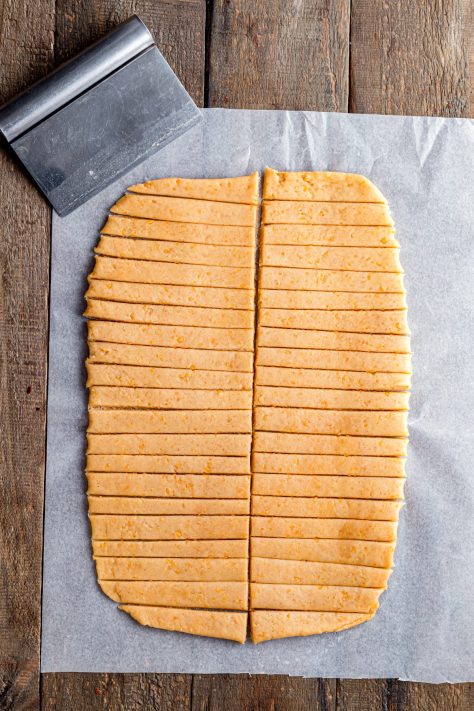 Dough being cut into strips.