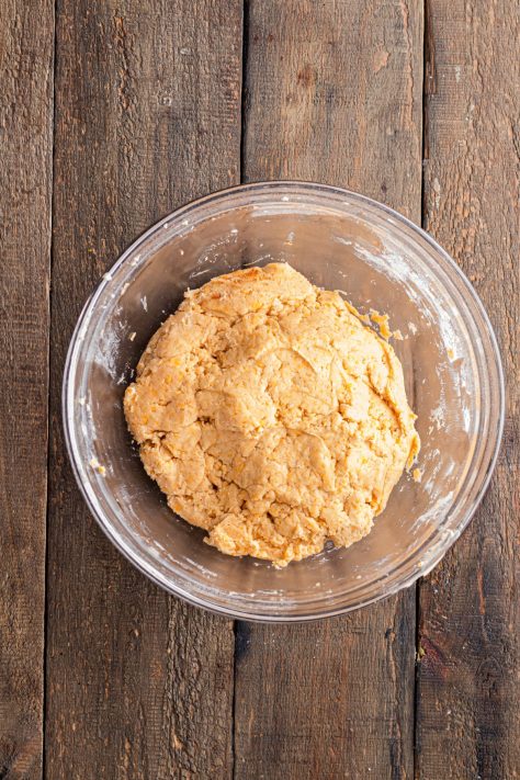 Cheese dough being formed in a bowl.