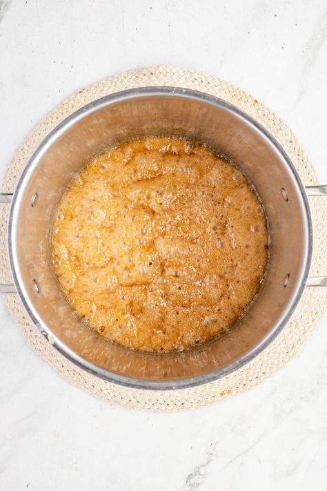 Brown sugar and butter being melted in a pot.