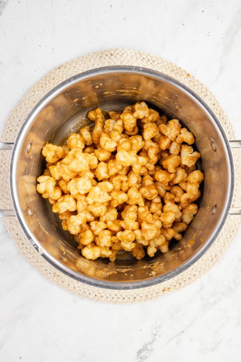Caramel coated puffed corn in a pot.