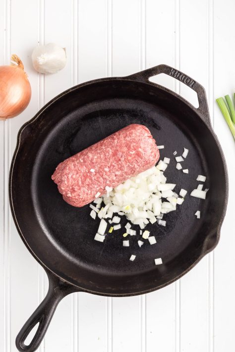 Ground beef and onion in a skillet.