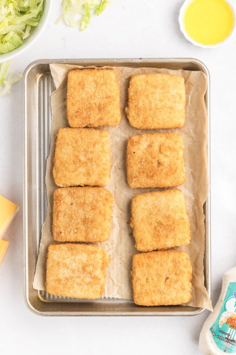 Fish filets on a lined baking sheet.