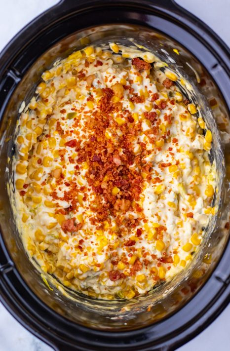 Bacon being added to a Dip in a Slow Cooker.