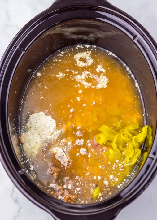 Uncooked Mississippi White Chicken Chili ingredients in a Slow Cooker.