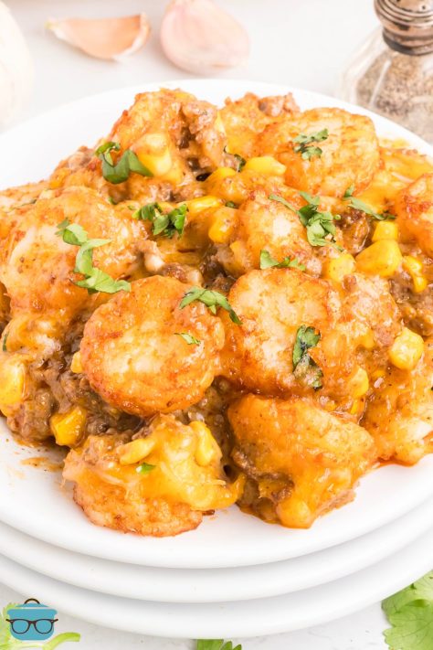 A small stack of plates with a huge scoop of Cowboy Casserole.