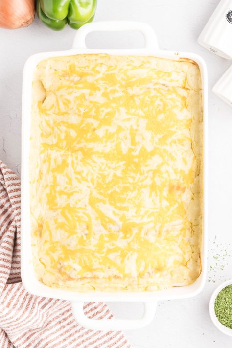 Baked Cheesy Beef Enchiladas in a baking dish.