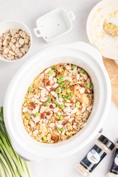 Green onions and almonds covering a chicken casserole in the Crock Pot.