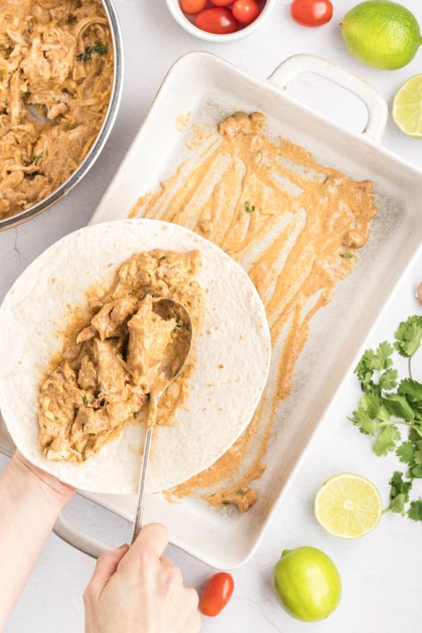 Chicken enchilada mixture on a tortilla.