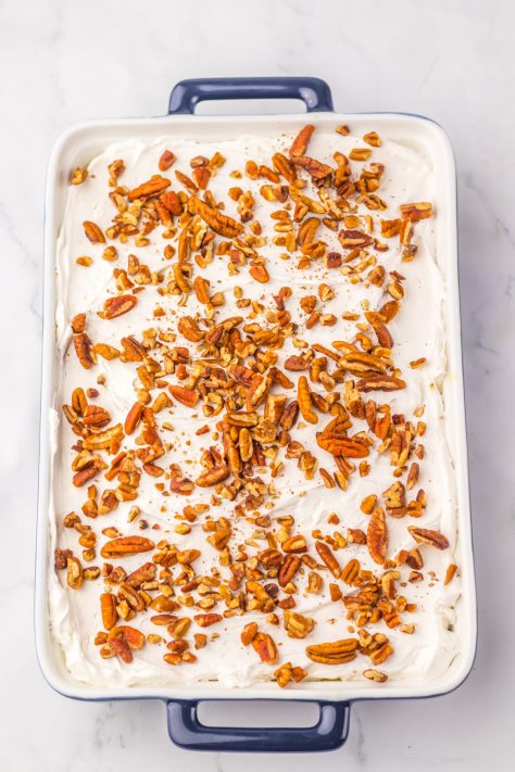 An iced and garnished Hummingbird Poke Cake.