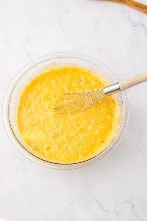 Cake batter in a bowl being whisked.