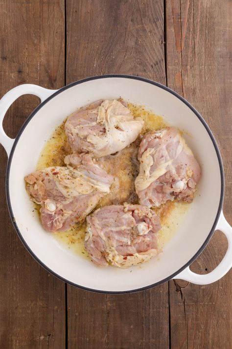 Chicken searing in a skillet.