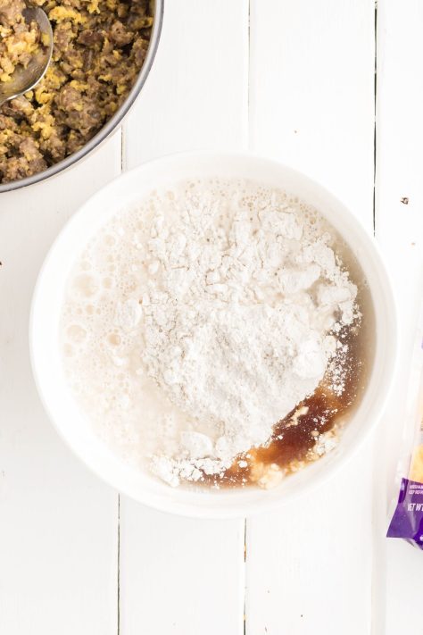 Pancake batter, syrup, and water being mixed.
