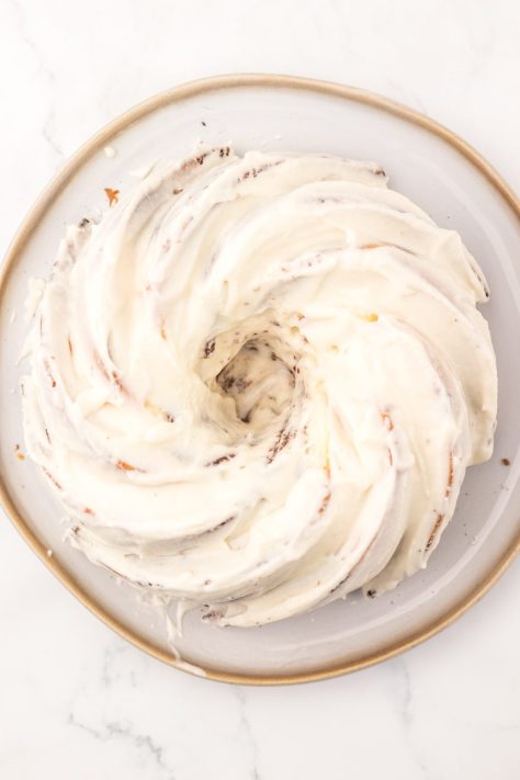 A frosted cake on a cake plate.