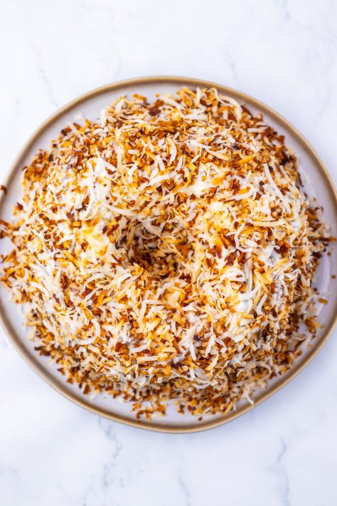 Toasted coconut flakes on an iced cake.