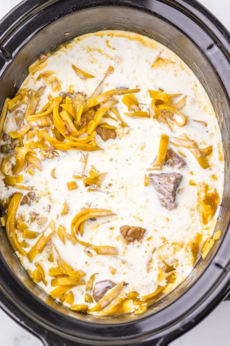 Heavy cream being added to a Slow Cooker.