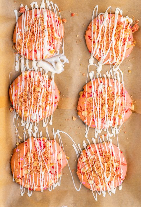 Garnished Strawberry Crunch Cookies on a piece of parchment paper.