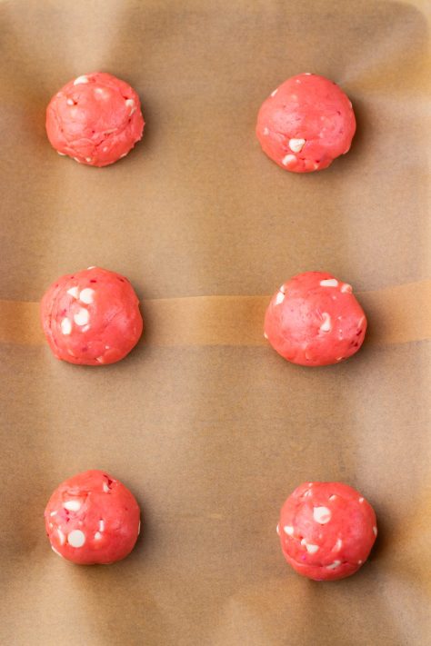 Cookie dough being rolled into balls.