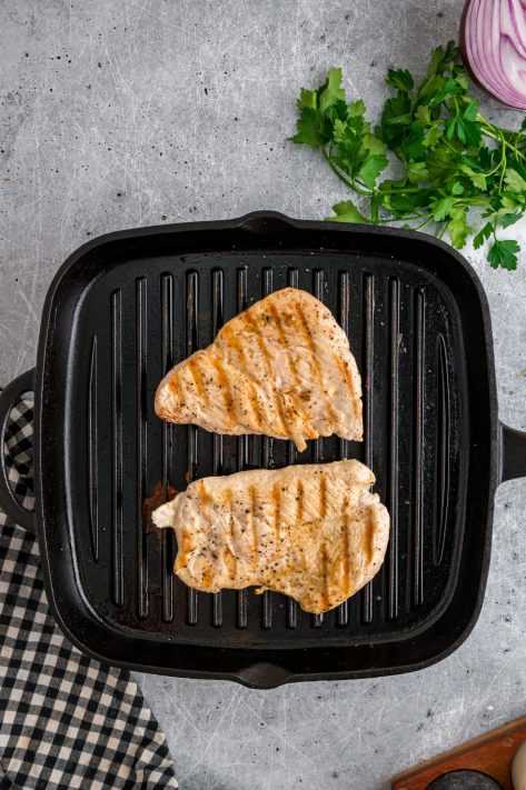 Chicken cooking on a skillet.