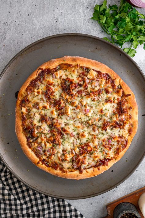 A baked, uncut BBQ Chicken Pizza.