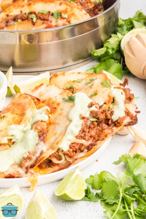 A couple of Crispy Beef Tacos on a plate.