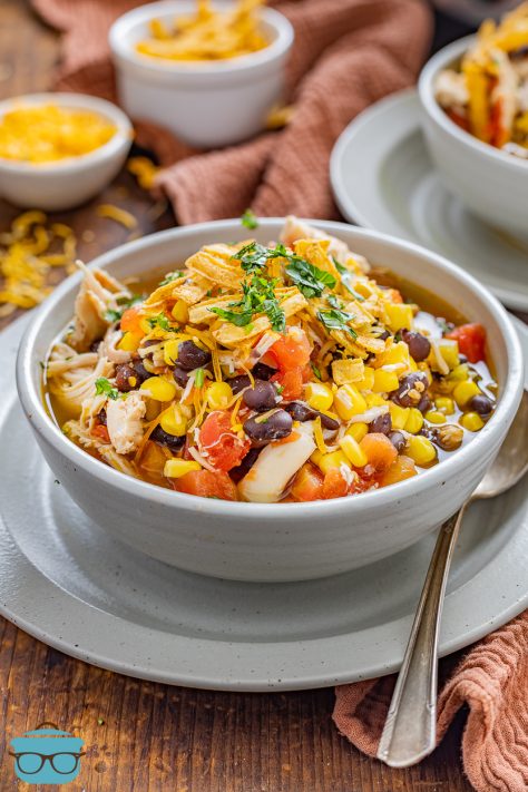 A large serving bowl of Chicken Fajita Soup with a spoon.