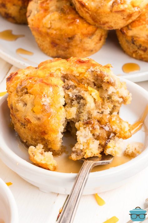 A fork splitting a McGriddle Muffin apart with syrup.