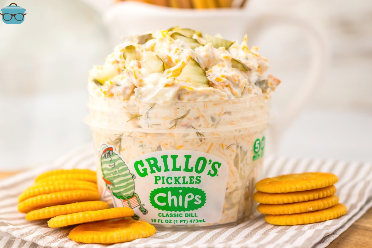 A serving container of Grilo's Pickle Dip with a few stacks of crackers.