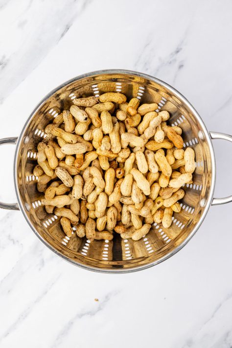 Rinsed peanuts in a colander.