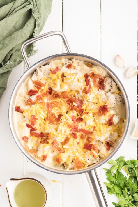 Bacon covered, cheesey, Chicken and Gnocchi bake in a skillet.
