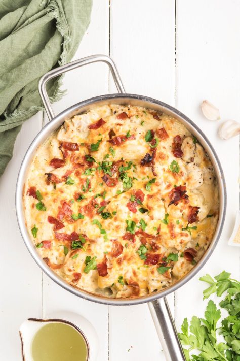 A garnished Creamy Crack Chicken Gnocchi skillet.