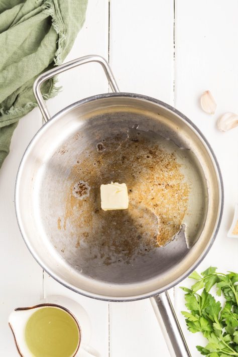 A skillet cooking butter.
