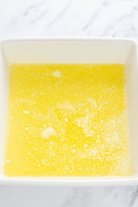Melted butter in a baking dish.