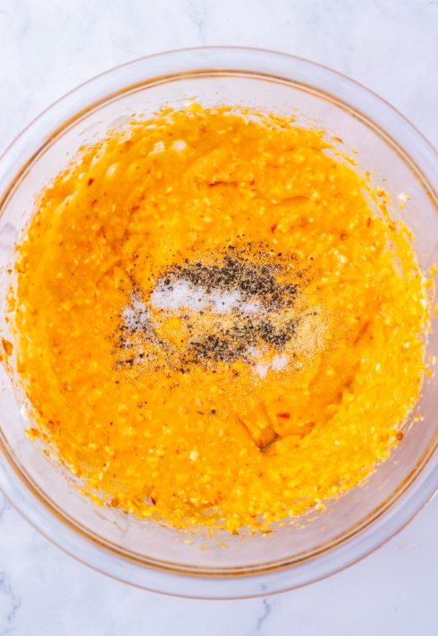 Cheese, salt, pepper, and onion powder added to a pepper jelly and cream cheese mixture.