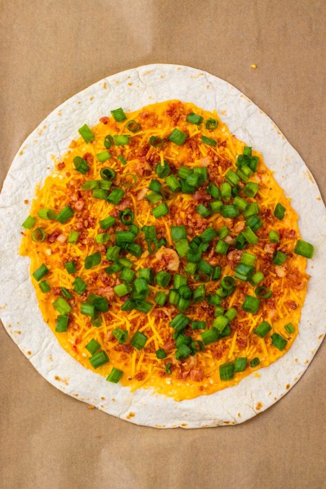 Tortilla with pepper jelly, cream cheese mixture with bacon and green onions.