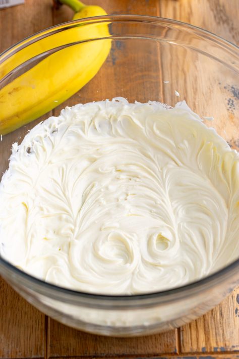 Cream cheese in a bowl being mixed.