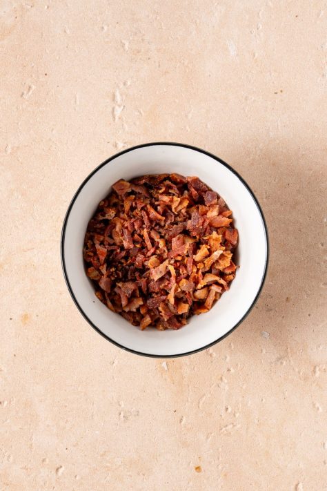 Cooked and crumbled bacon in a bowl.