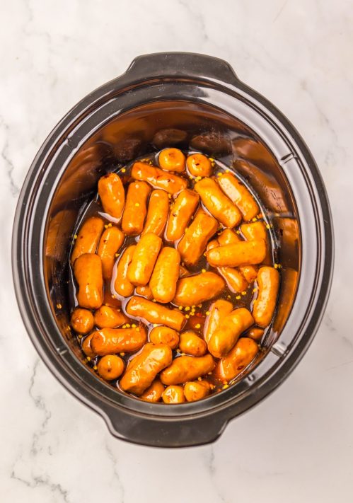 Smoked sausages cooking in a Slow Cooker.