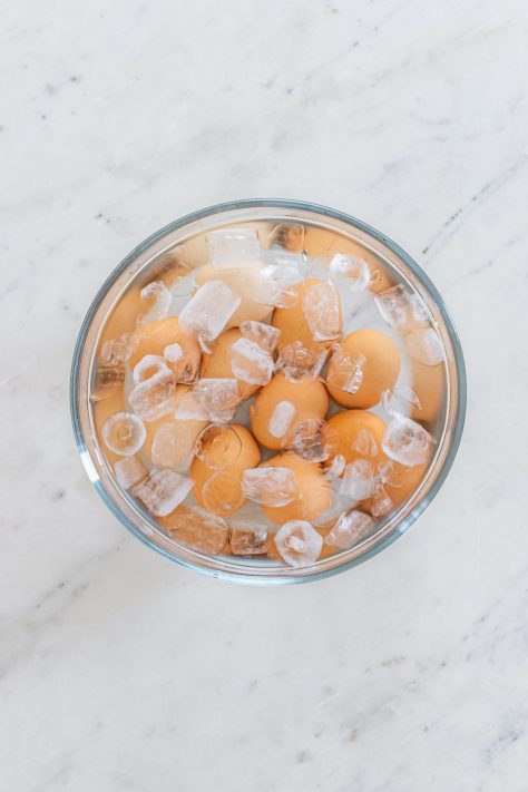 Cooked eggs in an ice bath.