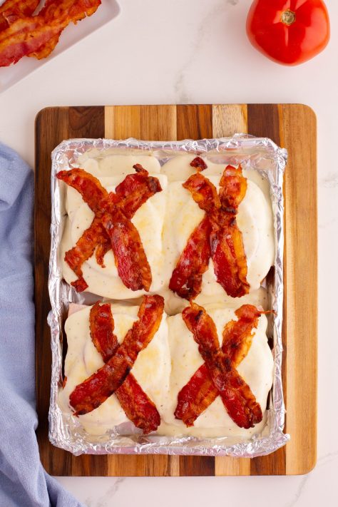 Bacon being added to the Hot Brown sandwiches.
