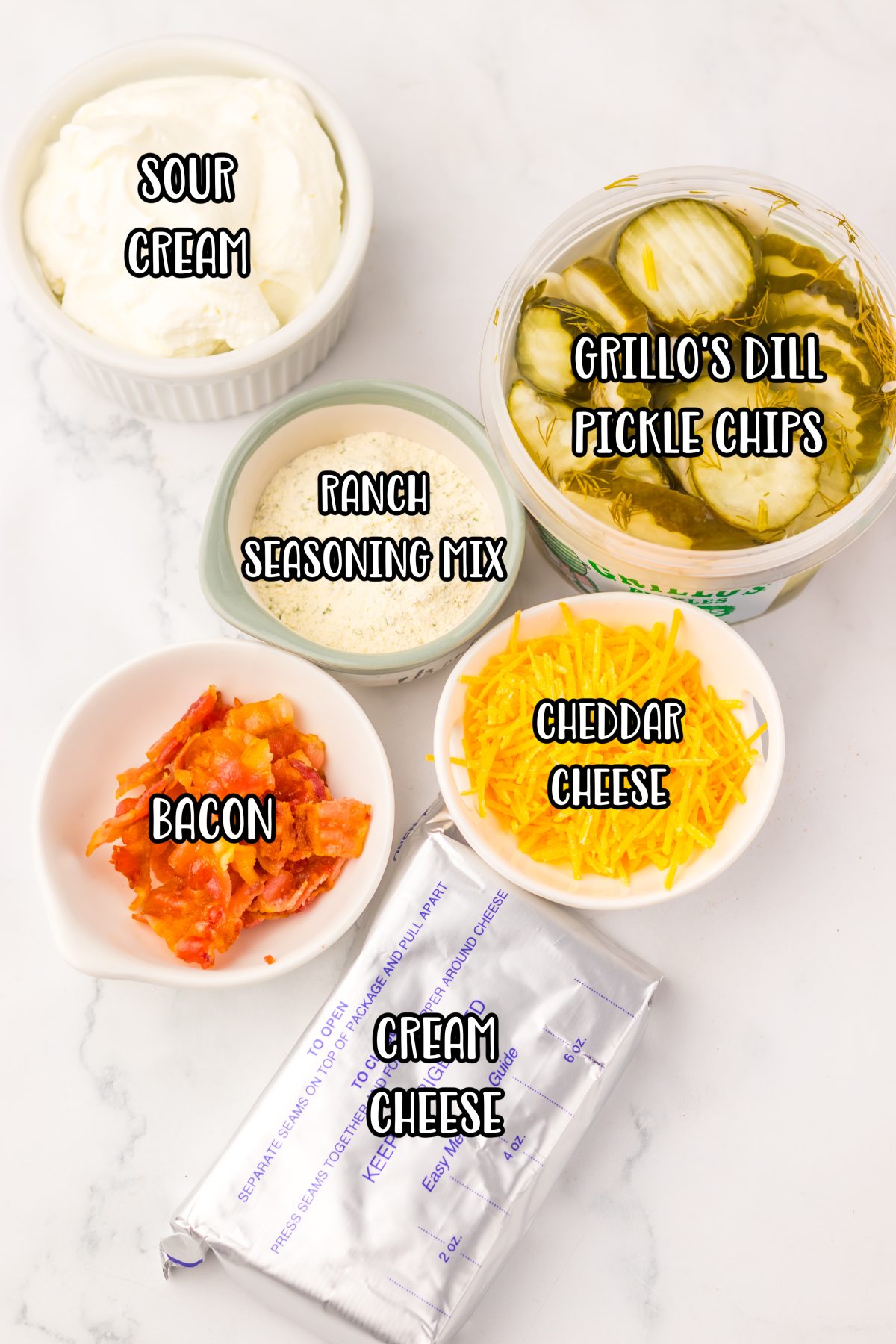 Sour cream, pickles, ranch seasoning mix, cheddar cheese, bacon, and cream cheese. 