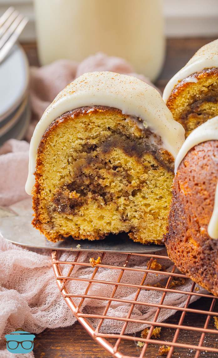A slice of Cinnamon Roll Pound Cake being removed from the rest of the cake.