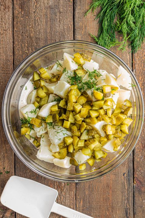 A bowl with the Dill Pickle Potato Salad ingredients waiting to be mixed.