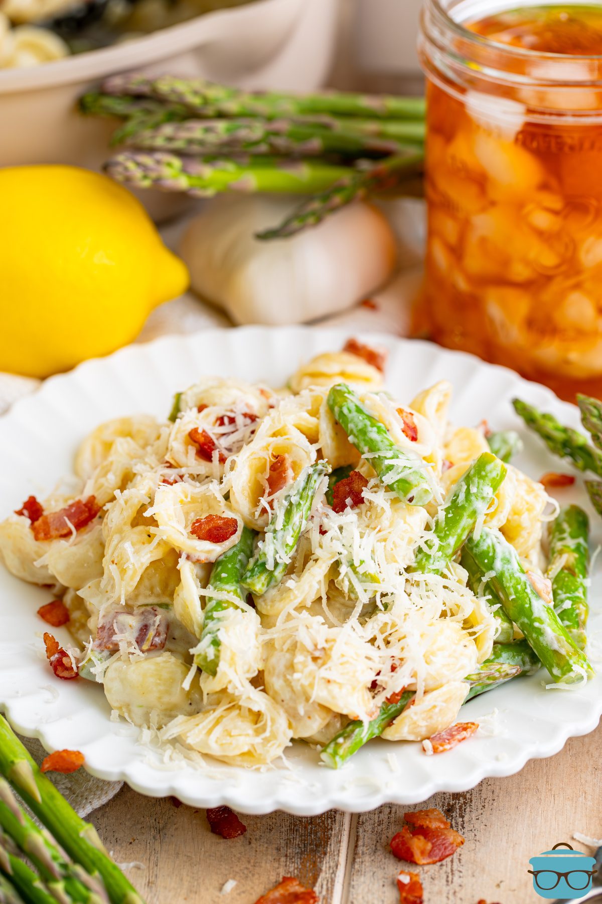 A white plate with Asparagus Pasta.