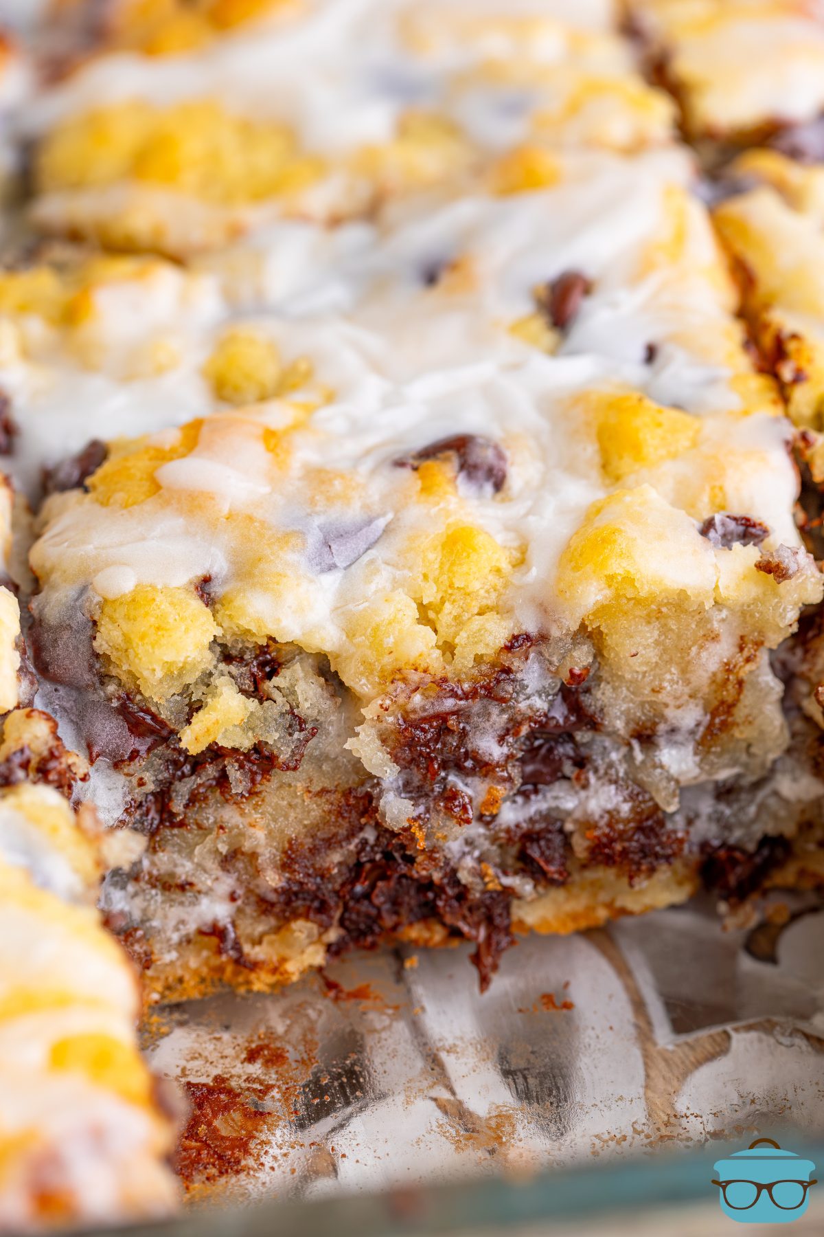 Close up looking at a few Chocolate Chip Butter Swim Biscuits and where one is taken out of the dish.
