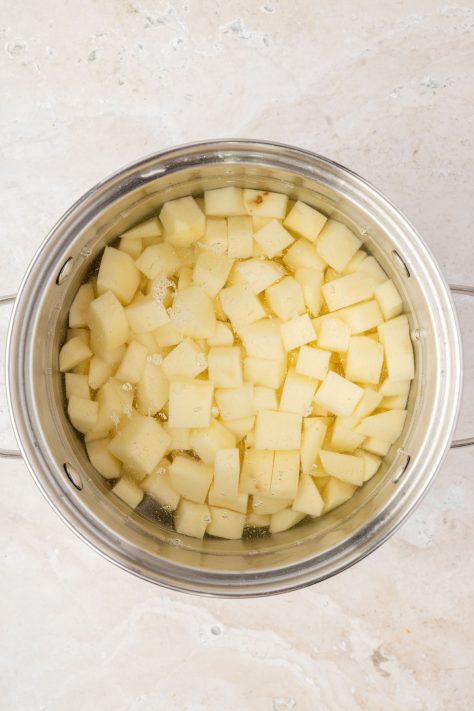 Potatoes boiling in a pot.