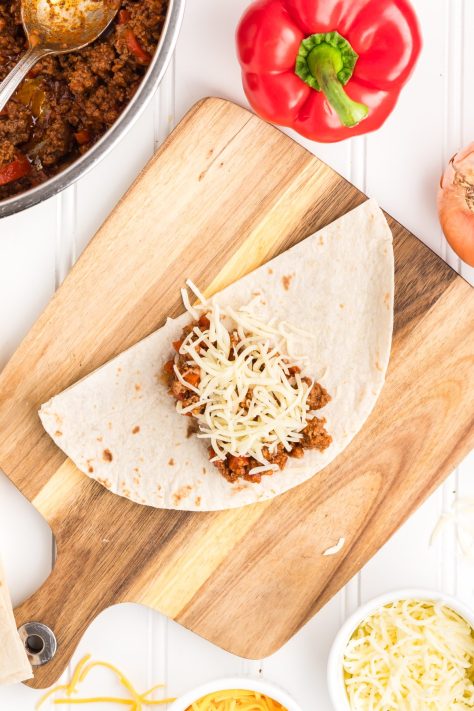 A tortilla with beef and meat mixture.