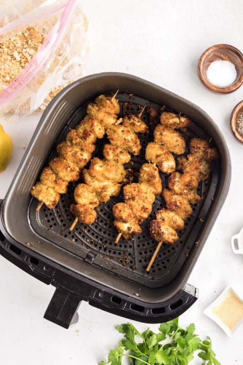 Chicken skewers in an Air Fryer basket.