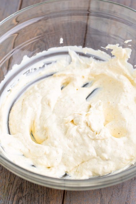 A bowl of cream cheese, mayonnaise, celery salt, garlic powder, onion powder, and black pepper.