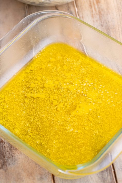 Melted butter in a baking dish.